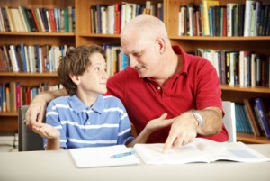 photo of man and boy studying