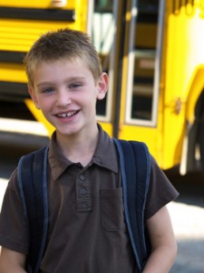 photo of boy by school bus